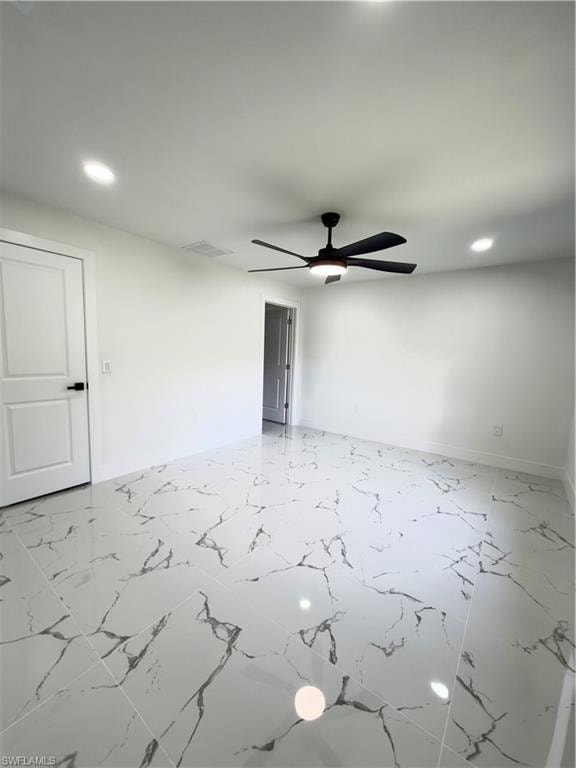 Empty room featuring recessed lighting, ceiling fan, and light marble finish flooring