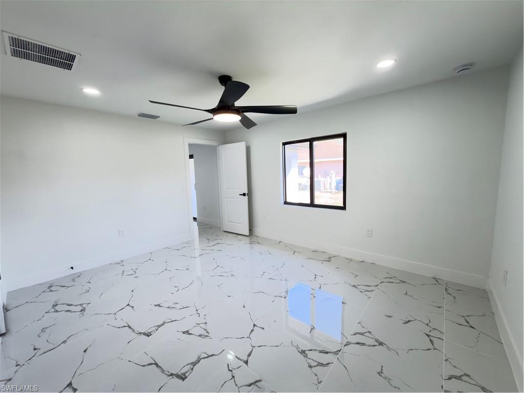 Unfurnished bedroom featuring light marble finish flooring, a ceiling fan, and recessed lighting