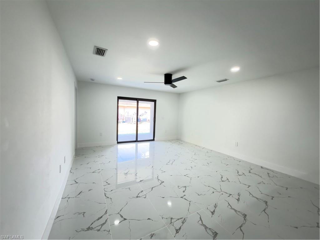 Spare room with light marble finish flooring, recessed lighting, and ceiling fan