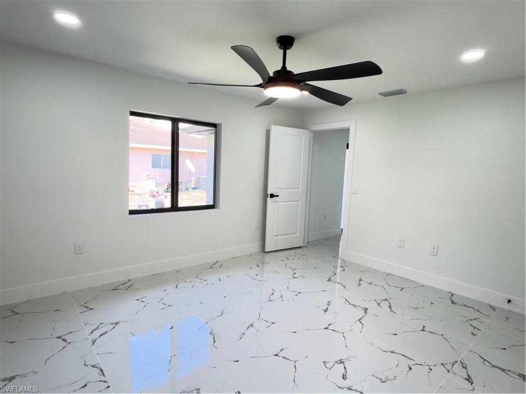 Unfurnished room with recessed lighting, ceiling fan, and light marble finish floors