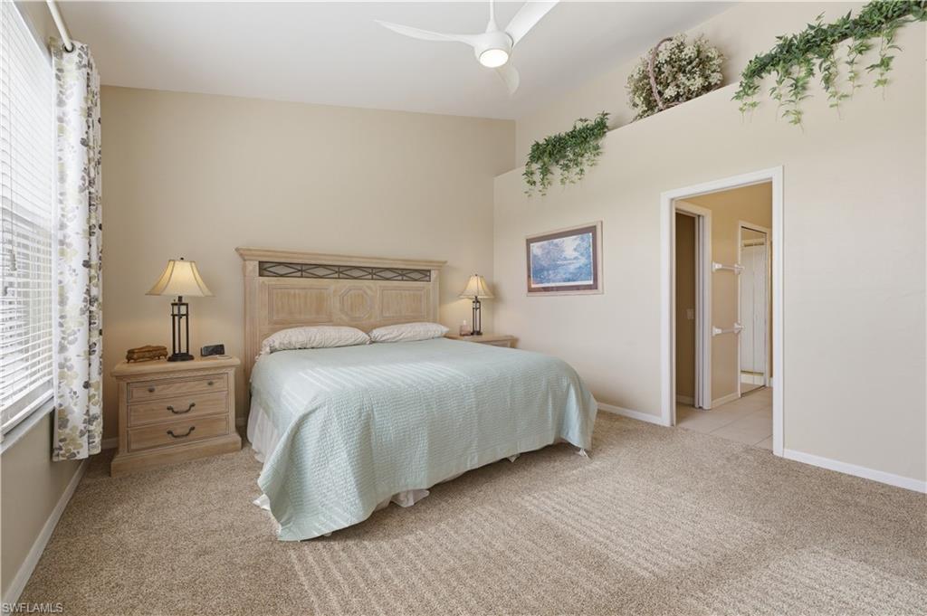 Bedroom featuring light colored carpet and a ceiling fan