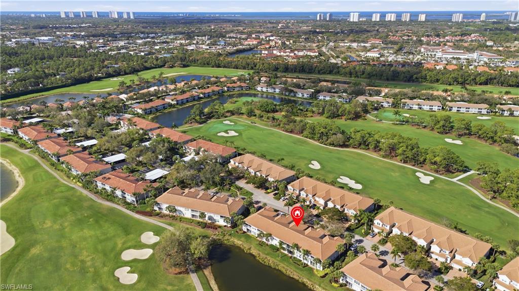 Aerial view of property's location featuring a large body of water and nearby suburban area