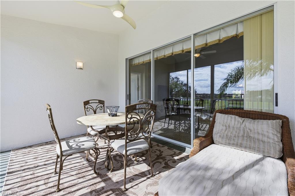 Sunroom with ceiling fan, outdoor dining space, and a patio