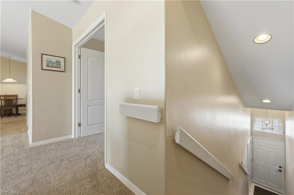Hall featuring recessed lighting, light carpet, and an upstairs landing
