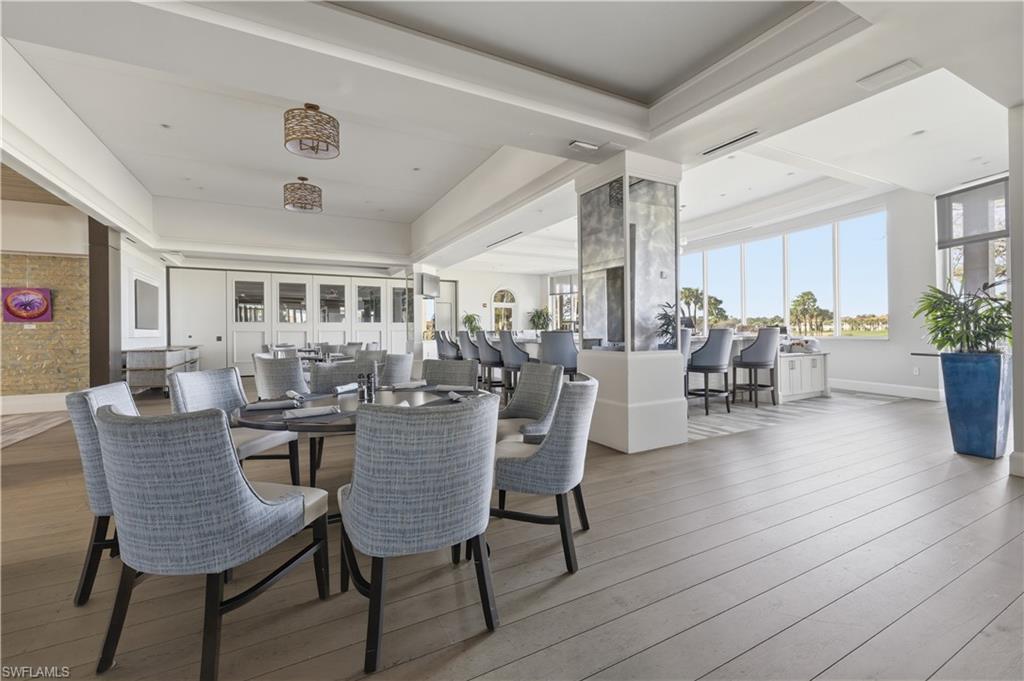 Dining area with light wood-style flooring and a tray ceiling