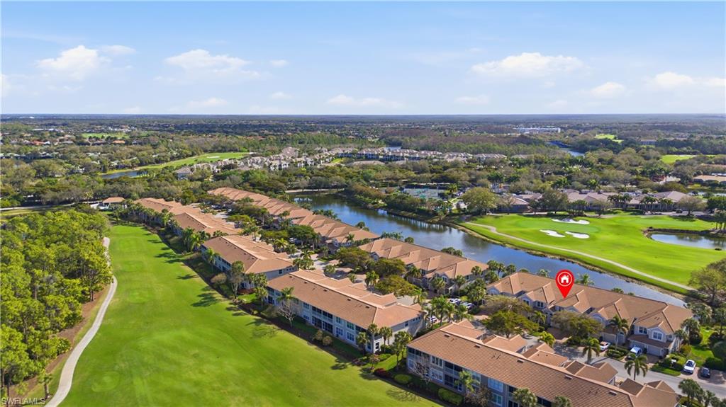 View of property location with a golf club, nearby suburban area, and a nearby body of water