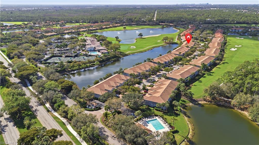 Aerial overview of property's location featuring a nearby body of water, a golf course, and nearby suburban area