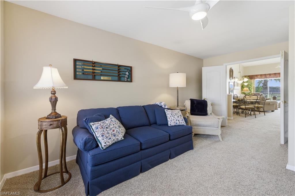 Living area with carpet flooring and a ceiling fan