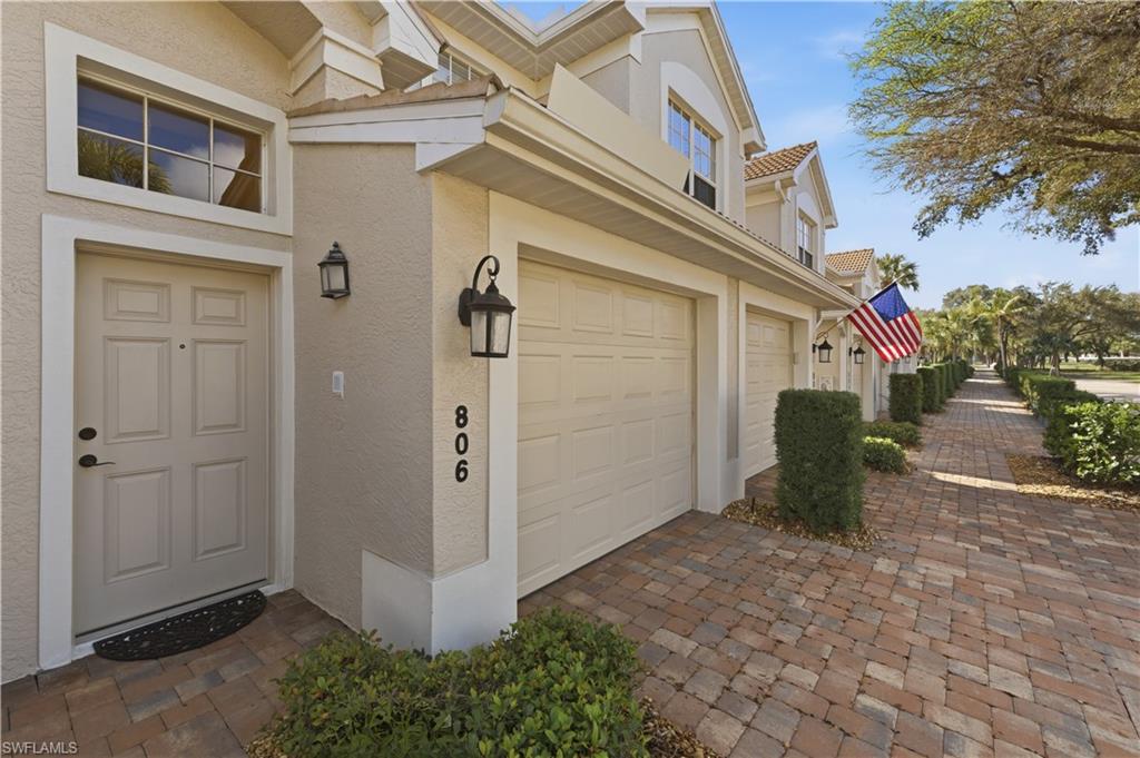 Entrance to property featuring stucco siding and driveway