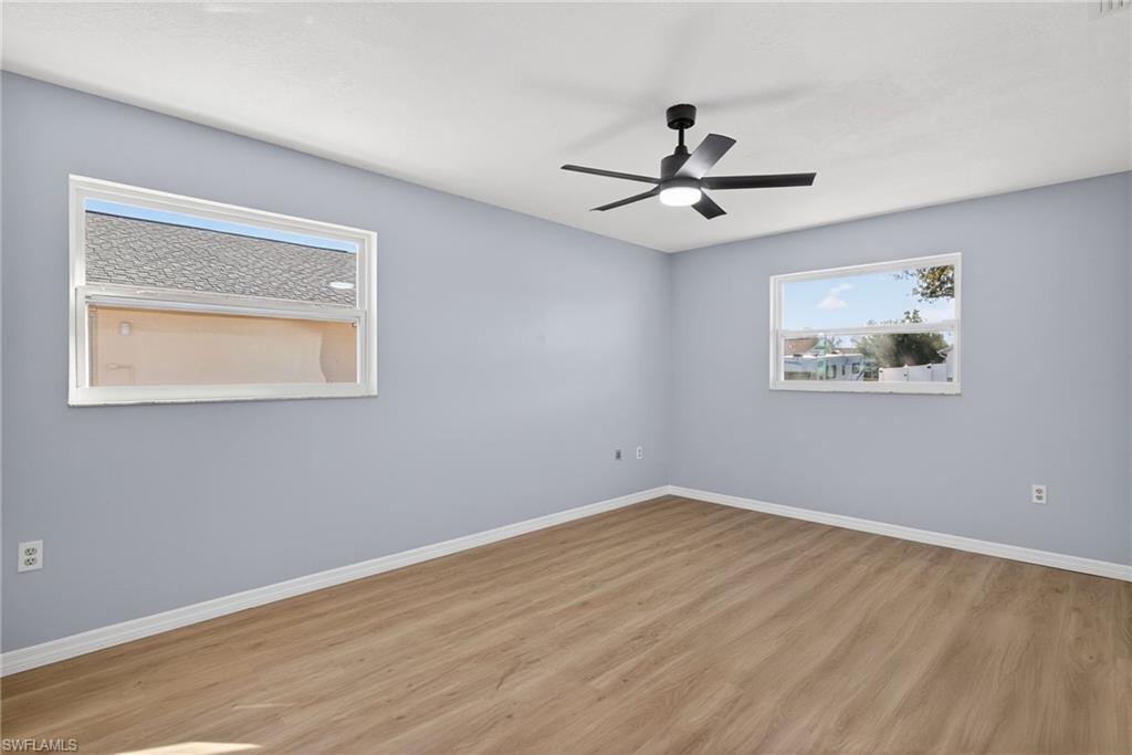 Unfurnished room featuring ceiling fan and light wood-type flooring
