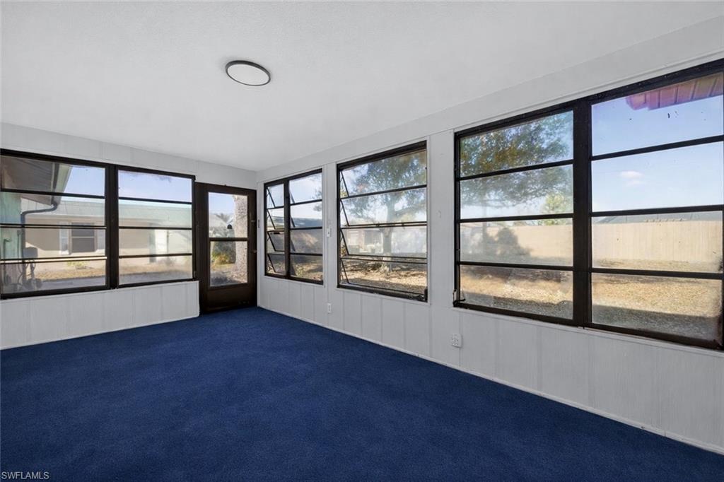Unfurnished sunroom with carpet flooring