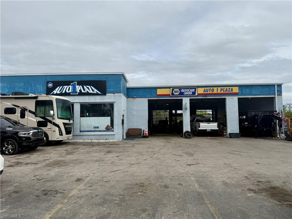 View of commercial property featuring uncovered parking