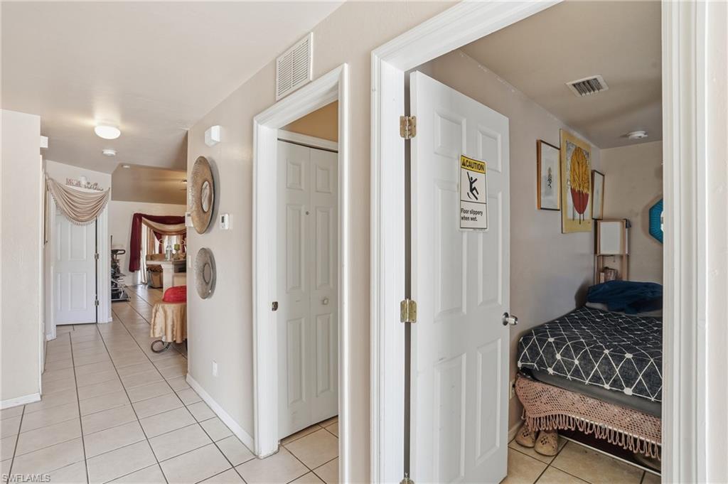 Hall with light tile patterned floors and baseboards