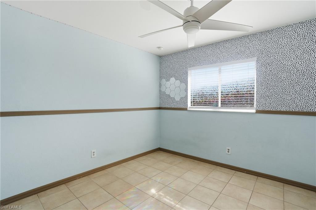 Spare room with a ceiling fan and baseboards