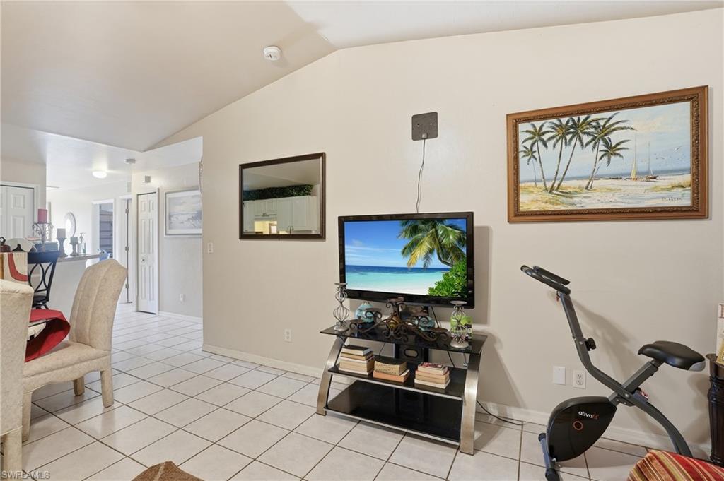Living area featuring vaulted ceiling and light tile patterned floors