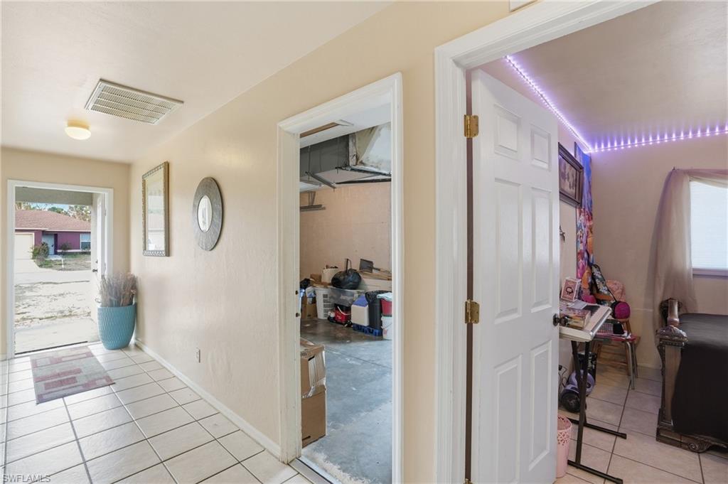 Hall featuring plenty of natural light and light tile patterned floors