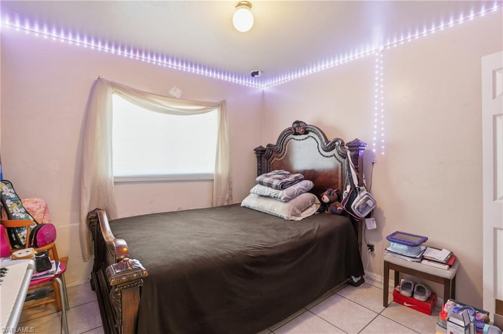 Bedroom with light tile patterned flooring