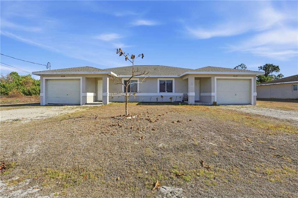 Ranch-style home with an attached garage, stucco siding, driveway, and roof with shingles