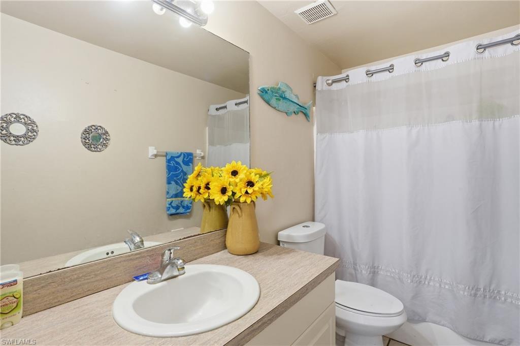 Bathroom with vanity and curtained shower