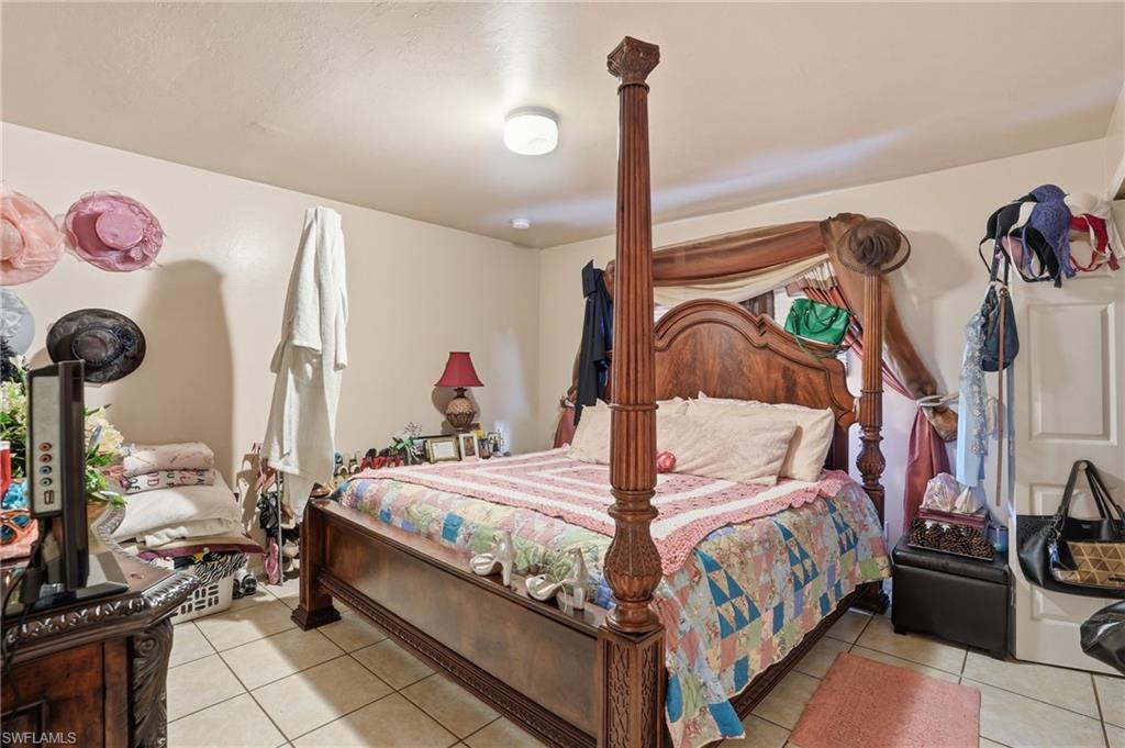 Bedroom with light tile patterned floors