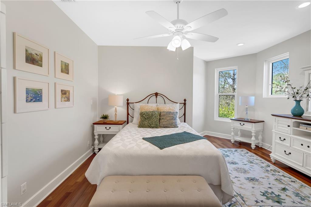 Bedroom featuring dark wood-type flooring, ceiling fan, and recessed lighting