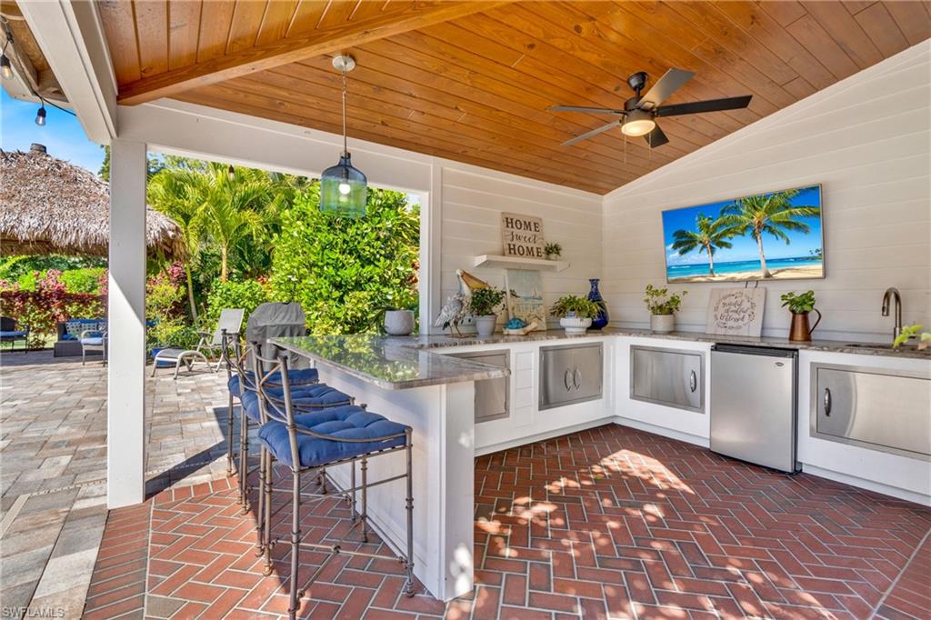 View of patio / terrace featuring area for grilling and a ceiling fan