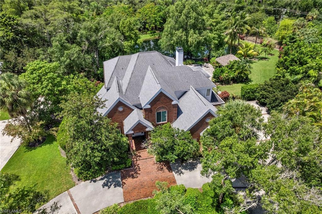 View from above of property with a tree filled landscape