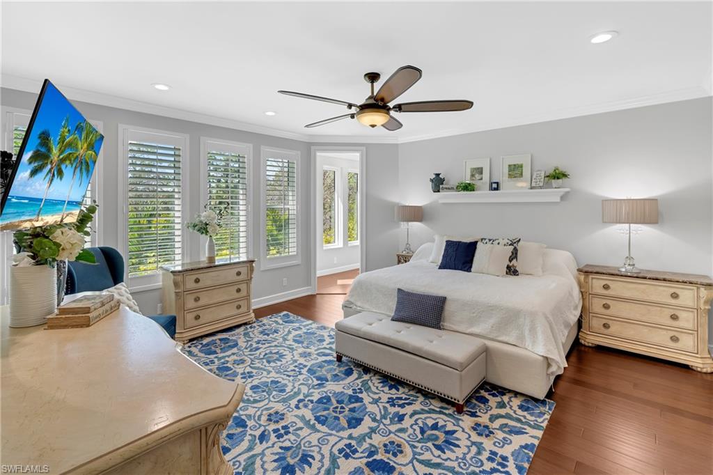 Bedroom featuring dark wood-type flooring, recessed lighting, ceiling fan, and crown molding