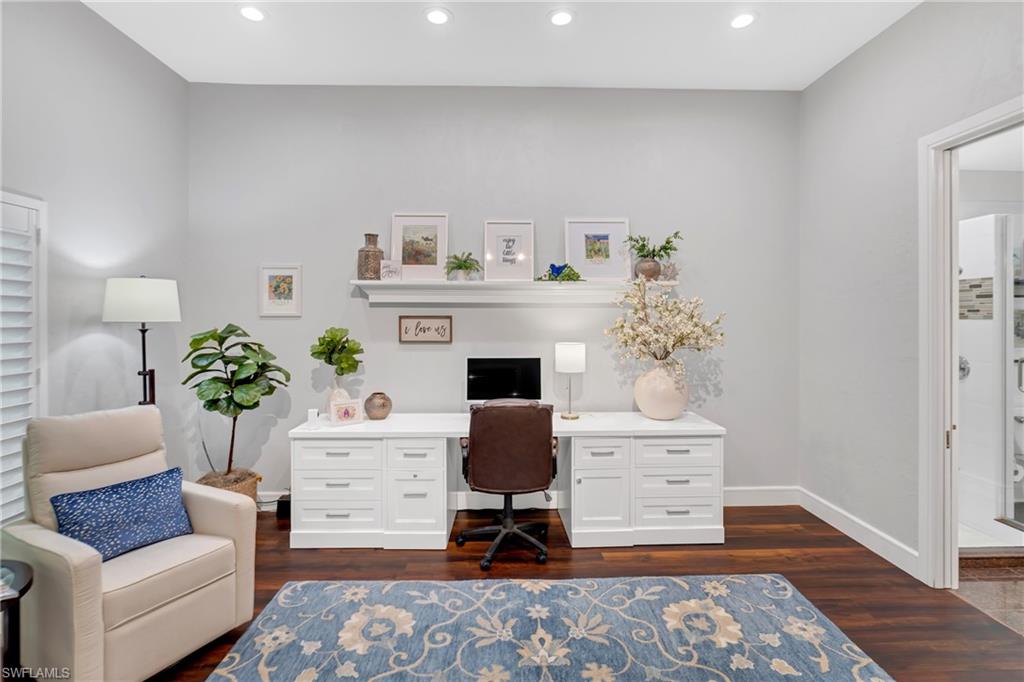 Office area with dark wood-style floors and recessed lighting