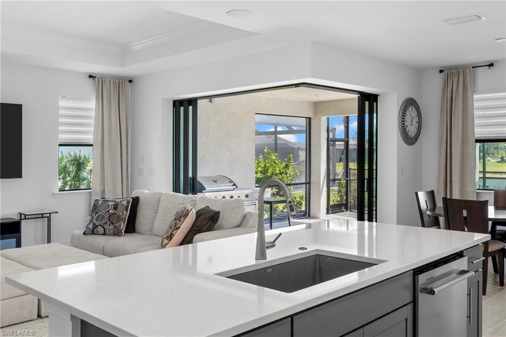 Zero corner sliding glass doors allow for a seamless transition from inside to the lanai/pool area.