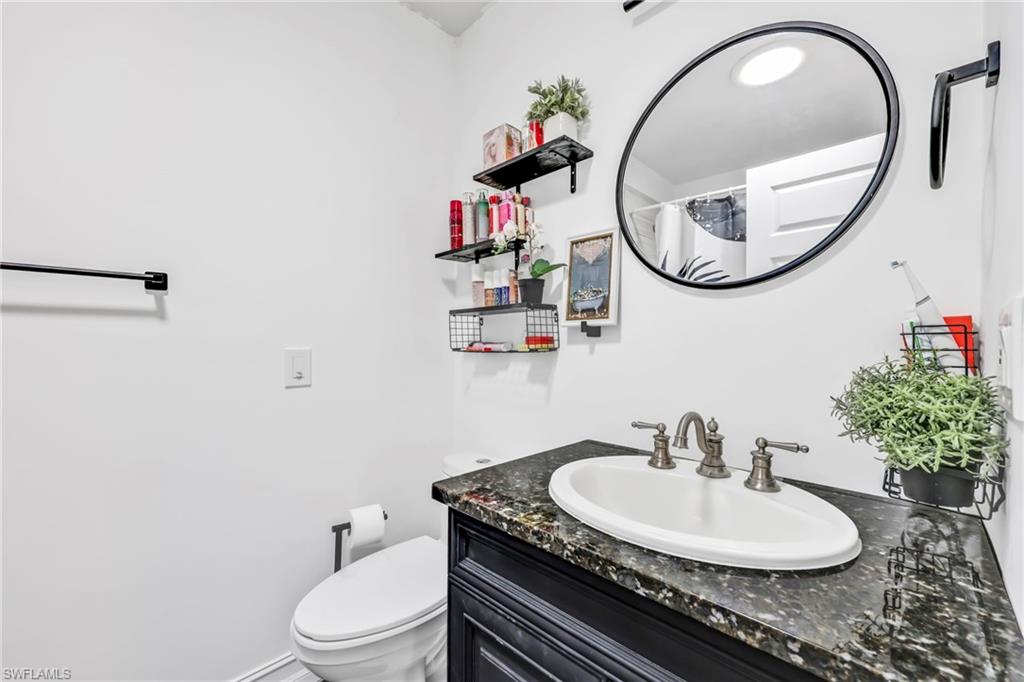Bathroom with vanity and curtained shower