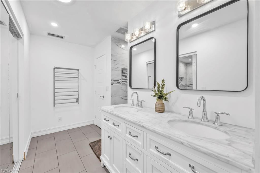 Bathroom featuring double vanity and recessed lighting