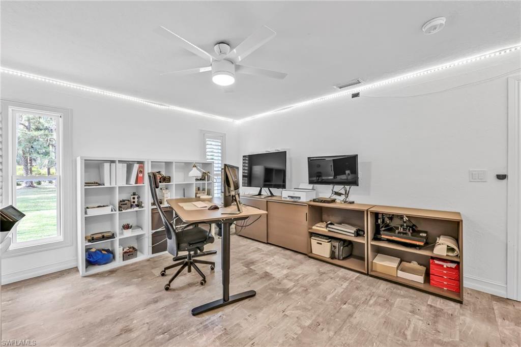 Office space featuring light wood-style floors and ceiling fan