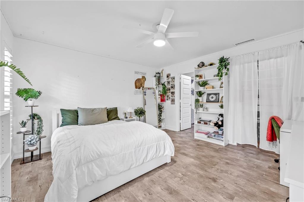 Bedroom with light wood-type flooring and a ceiling fan