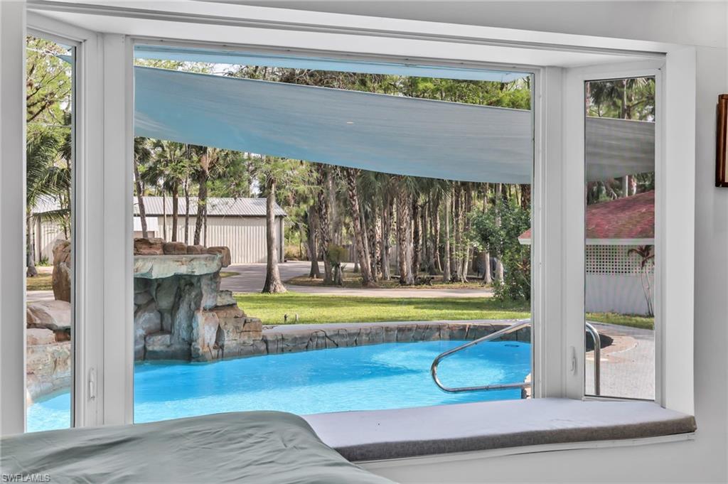 Outdoor pool featuring a lawn and a patio
