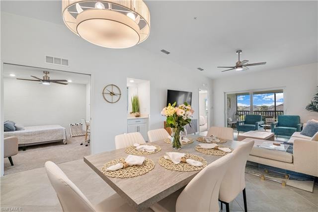 Tiled dining area with high vaulted ceiling and ceiling fan