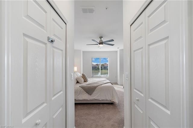 Bedroom featuring light colored carpet and ceiling fan