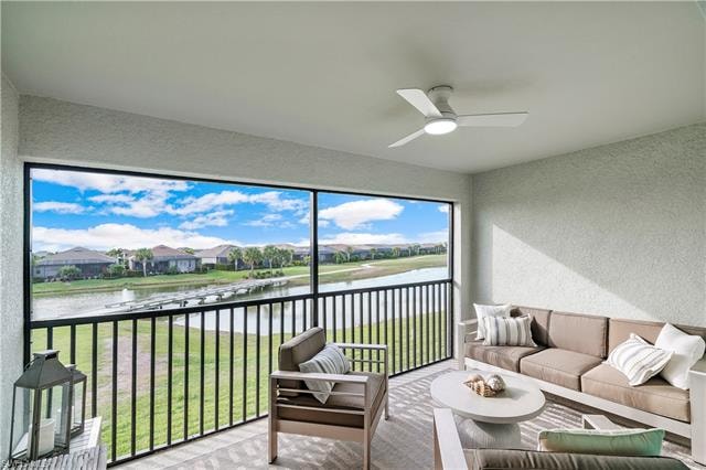 Sunroom with a water view and ceiling fan