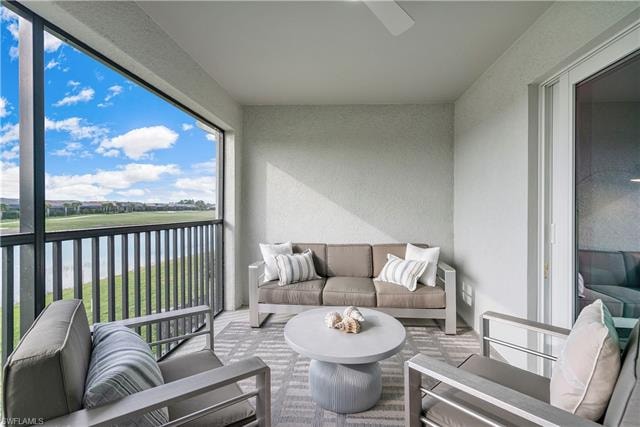 Sunroom featuring a water view