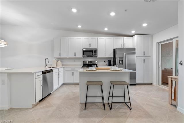 Kitchen with white cabinets, stainless steel appliances, and sink
