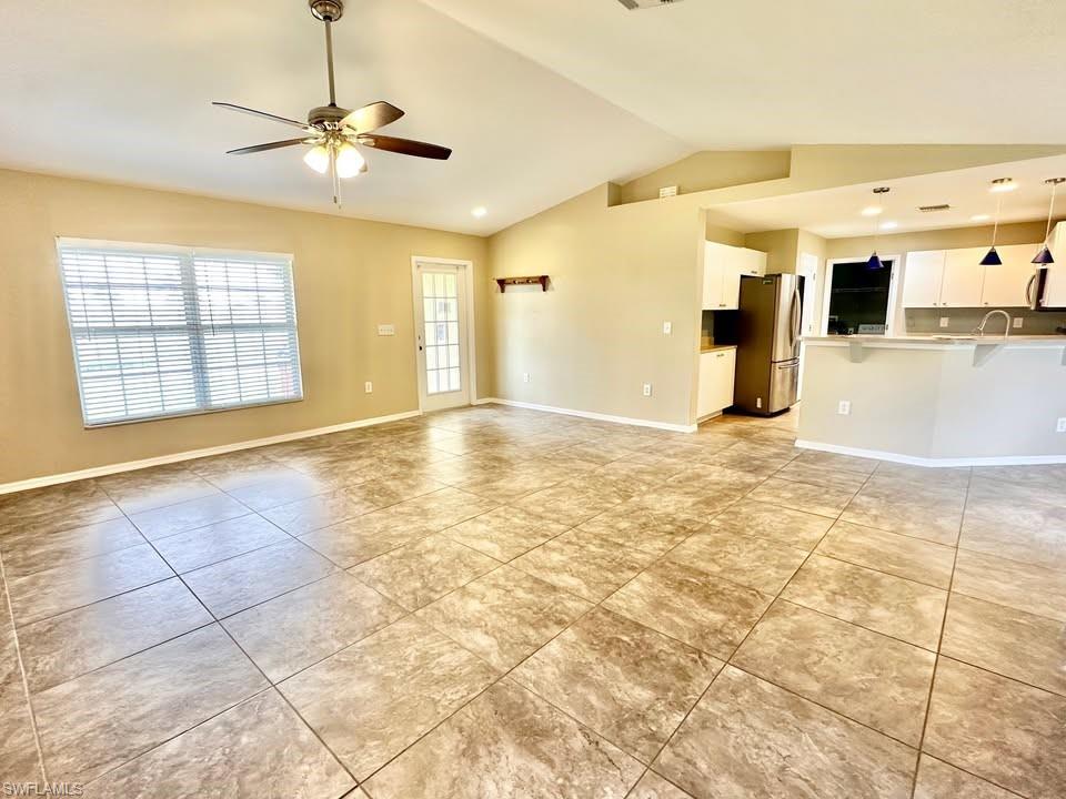 Unfurnished living room with a ceiling fan and recessed lighting