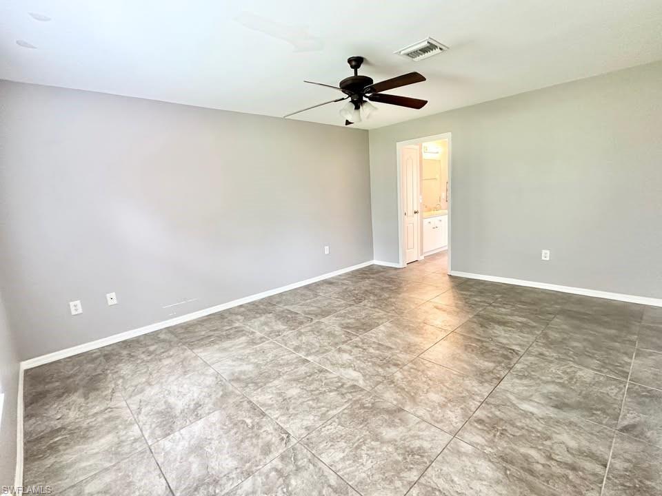 Empty room with baseboards and ceiling fan