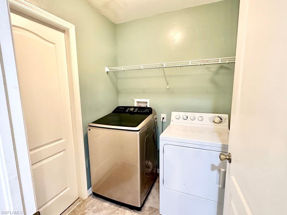 Laundry room featuring separate washer and dryer