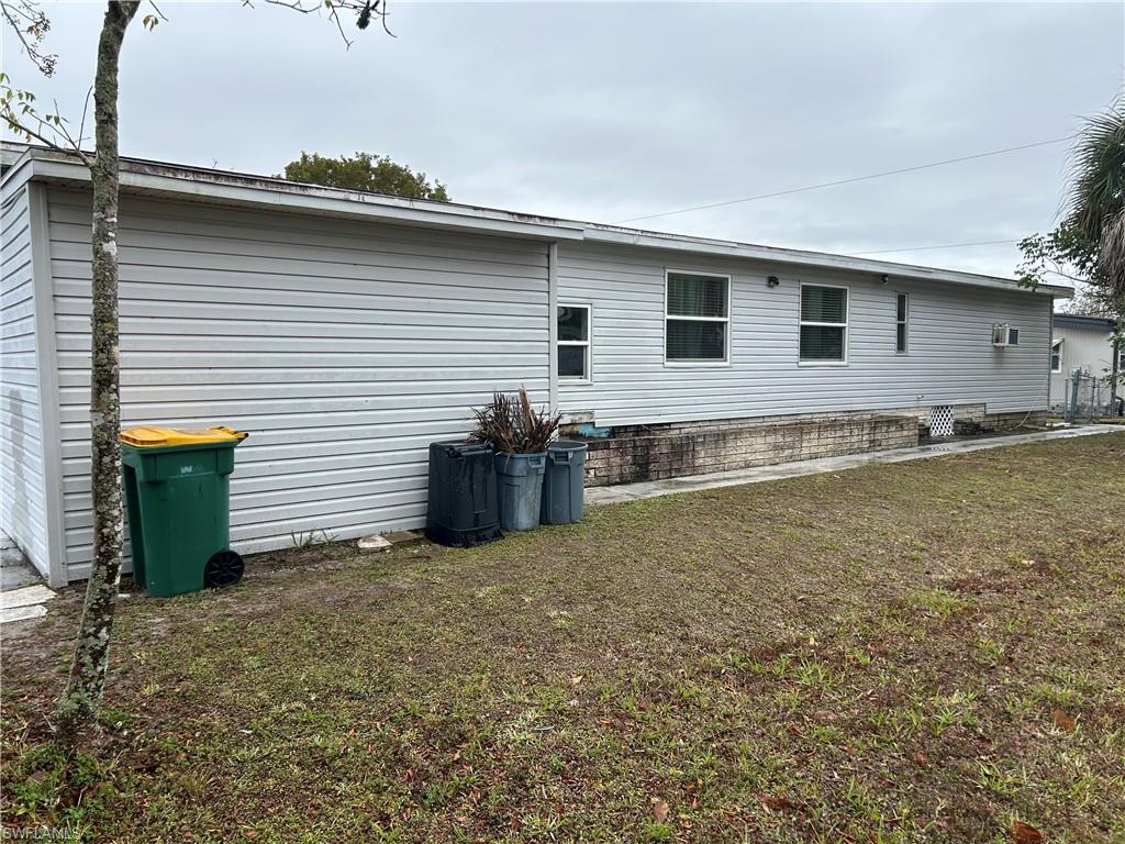 View of home's exterior with a lawn and a patio