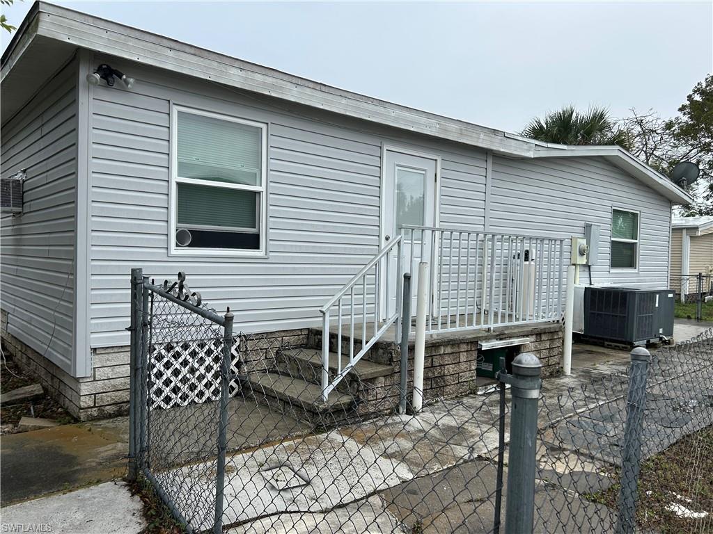 Rear view of property with a gate and a patio area