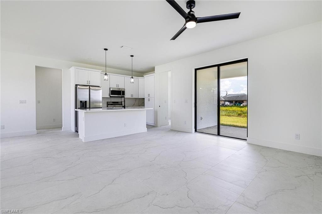 Bedroom featuring white walls and marble-style flooring