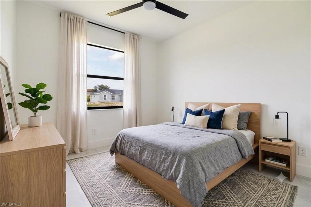 Unfurnished bedroom with a ceiling fan, a closet, and light marble finish floors