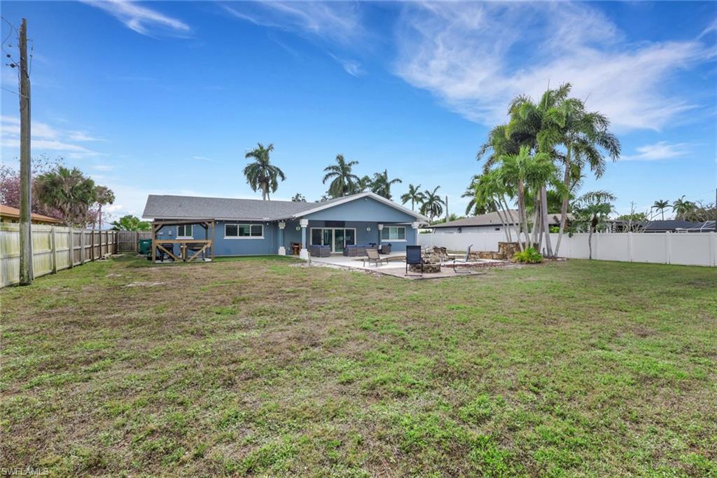 Back of house with a patio area and a fenced backyard