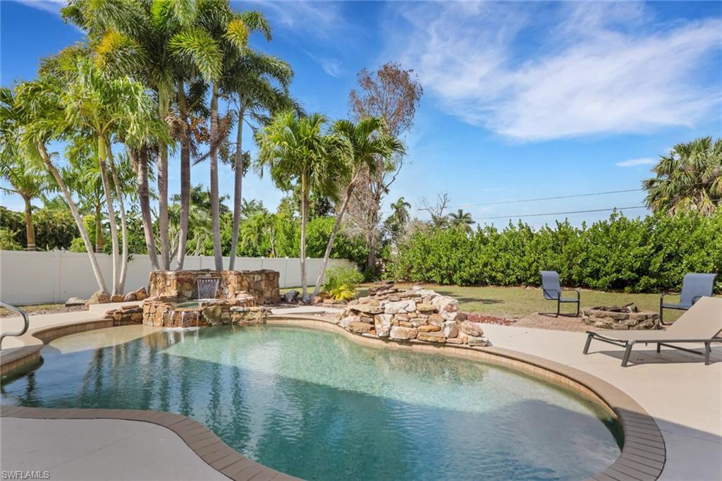 View of swimming pool featuring patio surround and a fenced backyard