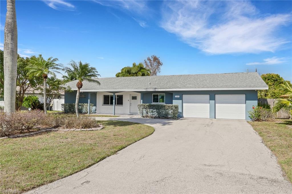 Single story home with driveway, a shingled roof, stucco siding, and a garage